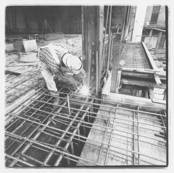 Construction worker welding forms for the second floor in the new Exchange Bank building, 545 Fourth Street, Santa Rosa, California, 1971