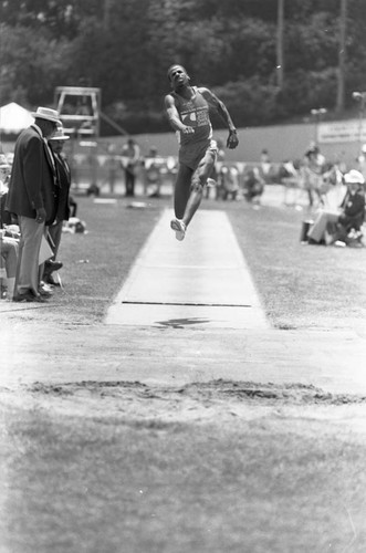 Athlete completing a long jump, Los Angeles, 1982