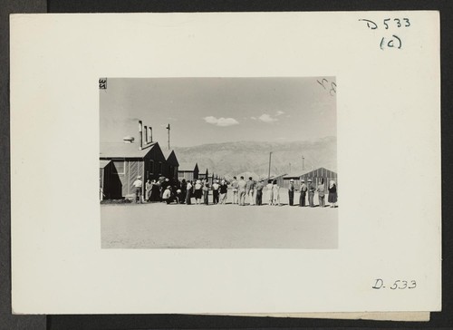 Manzanar, Calif.--Ready to pass into dining room at Manzanar, a War Relocation Authority center for evacuees of Japanese ancestry. Photographer: Stewart, Francis Manzanar, California