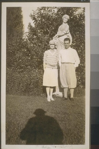 [Man and woman in front of statue] Helen Sunborg [?]