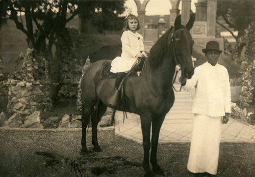 Prisoner (as servant) with daughter of staff member on horseback, San Quentin State Prison, circa 1915 [photograph]