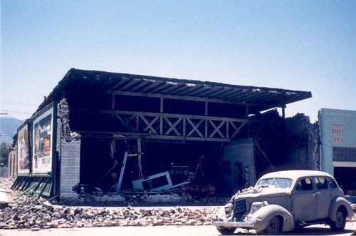 Damaged car and building