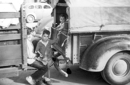 Linnell Camp children playing near packed trucks