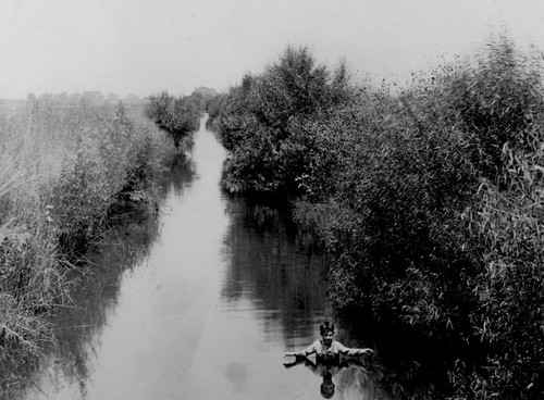 Child Swimming in Canal