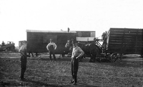 Cook wagon and sorghum wagon in front of the blacksmith shop