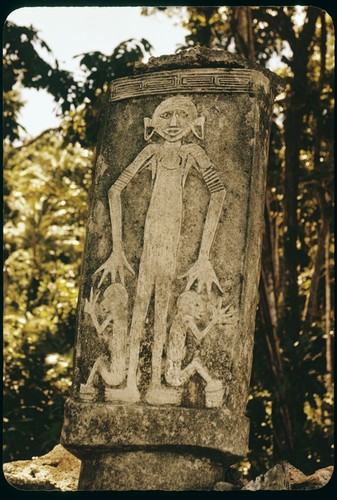 Dolo or burial urn chisled from a single block of limestone and set upon a pyramid of coral slab