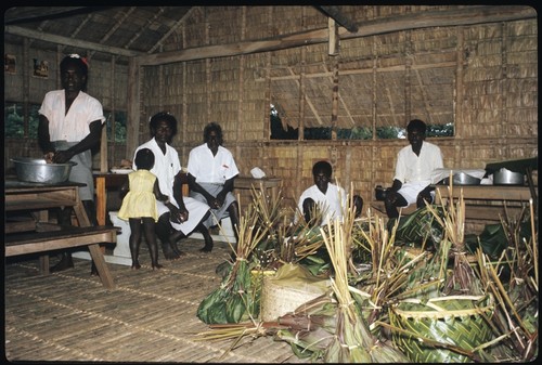 Men with divding wrapped food for feast