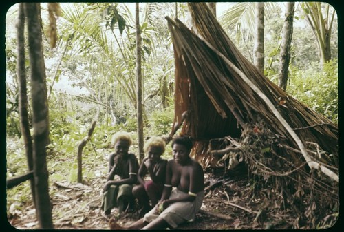 Woman and children next to a structure