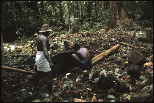 Men making petroglyph carving