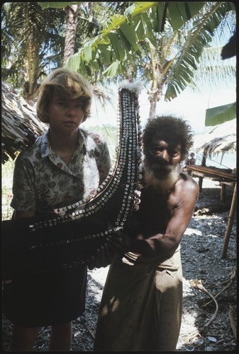 Frances Harwood and man with miniature canoe