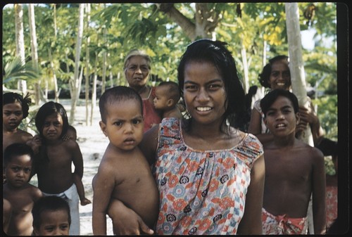 Woman and infant, with surrounding group