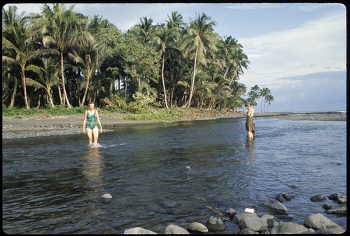 Anne Scheffler and Frances Harwood wading at the shore