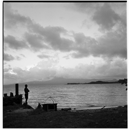 Man at shore with fishing gear