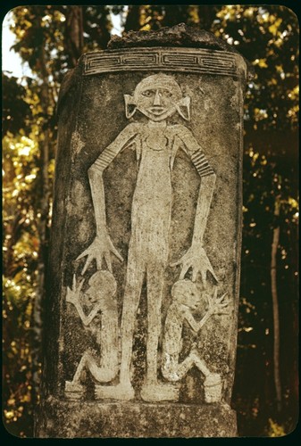 Dolo or burial urn chisled from a single block of limestone and set upon a pyramid of coral slab