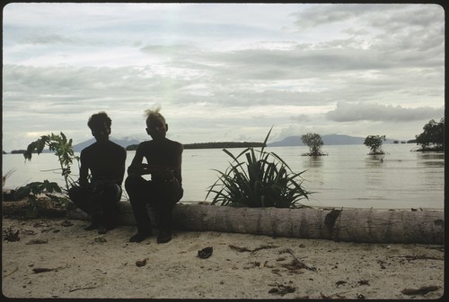 Portrait of two men by shore