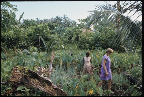 Woman and Anne Scheffler walking through a garden