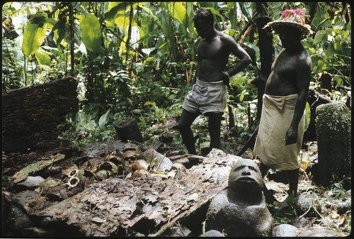 Men with skull shrine and man figured stone sculpture