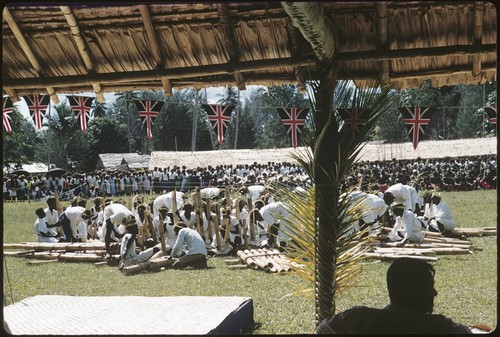 Official gathering including musicians with large panpipes, and british flag pennants