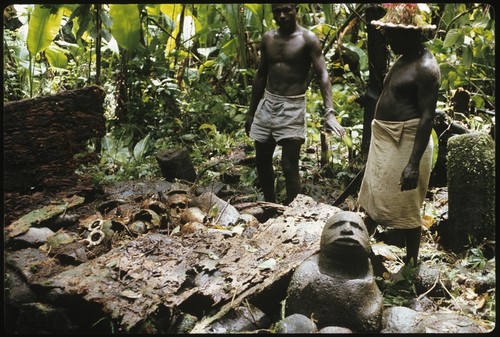 Men with skull shrine and carving