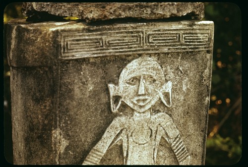 Closeup of a dolo or burial urn chisled from a single block of limestone and set upon a pyramid of coral slab