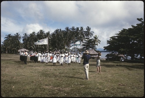 Christian Fellowship Church members with flags and music, Caucasians taking pictures