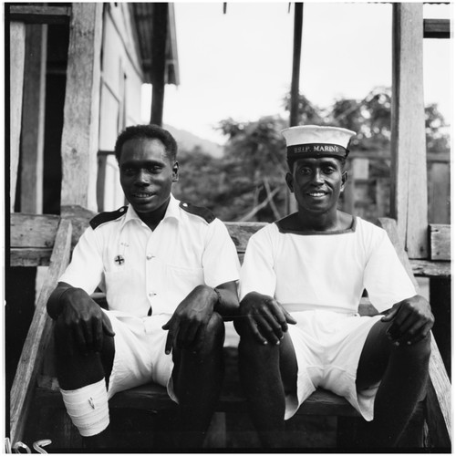 Men in uniforms on steps of building