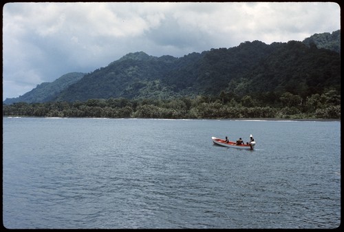 Men on boat heading towards island