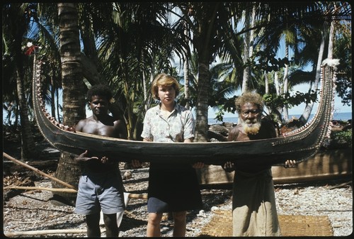 Frances Harwood with two men and miniature canoe