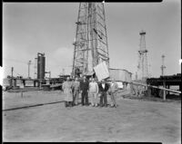 Men standing in front of a Pacific Drilling Corporation oil well at the Playa del Rey oil field, Los Angeles, 1935