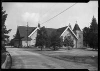 Victorian church or residence next to a road with a zanja (irrigation channel), California, circa 1880-1895