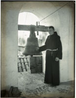 Monk in bell tower with the Great Bell at Mission Santa Barbara, Santa Barbara, 1898