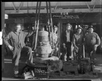 Workers gathered around a casing elevator, probably at the Venice or Playa del Rey oil field, Los Angeles, 1930