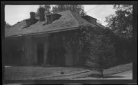 Cottage with ivy and rocking chair (unidentified), California