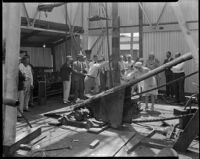 Well-dressed men and women on the drill floor of an oil well, probably at the Venice or Playa del Rey oil field, Los Angeles, circa 1930