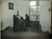 Franciscan Brother Peter playing the organ at Mission Santa Barbara, Santa Barbara, circa 1898-1899