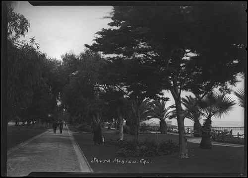 Two men striding down wide walkway in Palisades Park, Santa Monica, circa 1915-1925