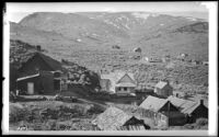 Cabins or cottages scattered across an unidentified mountain valley, California