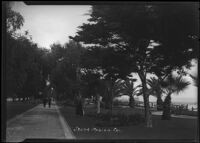 Two men striding down wide walkway in Palisades Park, Santa Monica, circa 1915-1925