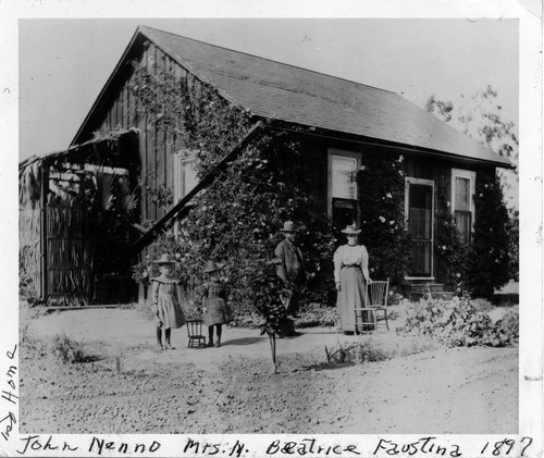 Photograph of John Nenno and family standing outside his first home in Placentia