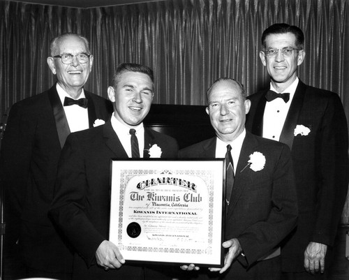 Photograph of members holding Kiwanis Club of Placentia Charter