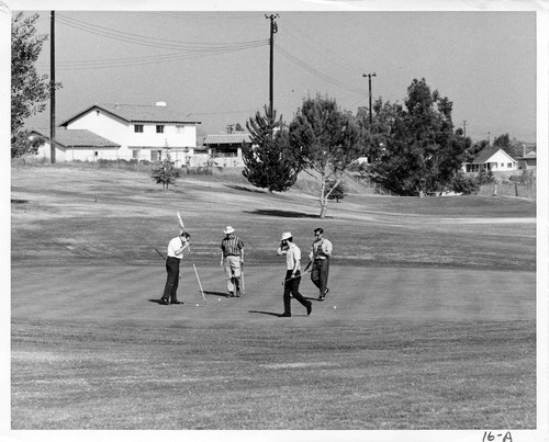 Photograph of golfers on one of the greens at the Alta Vista Country Club