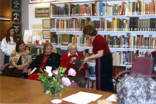 Photograph of presentation of printed oral history to Fred Agurrie