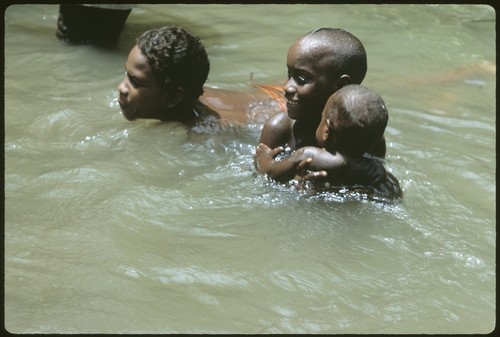 Girls swimming in the creek running by Uka'oi