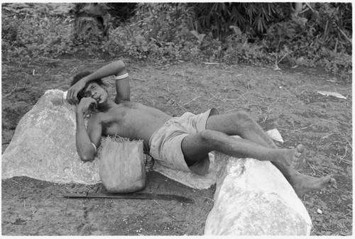 Man resting by stone