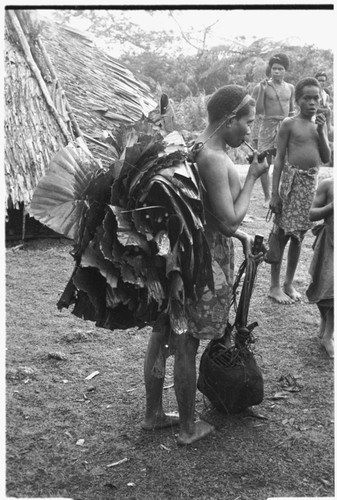 Woman bringing leaves for making the leaf oven