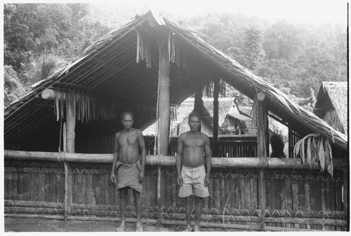 Two men in front of house