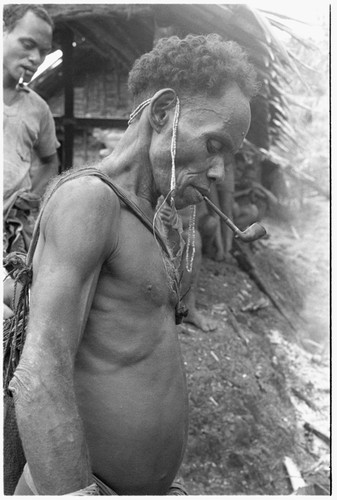 Elota, with string of kofu shell money behind ears, probably the first received for the feast, which will go in his ruu ritual bundle