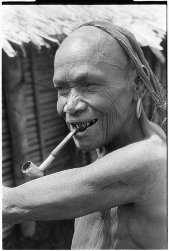 Portrait of older woman, with homemade pipe