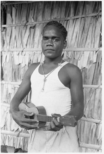 Seda, eldest son of Folofo'u and Boori'au, of Uka'oi, with swollen eye and ukulele