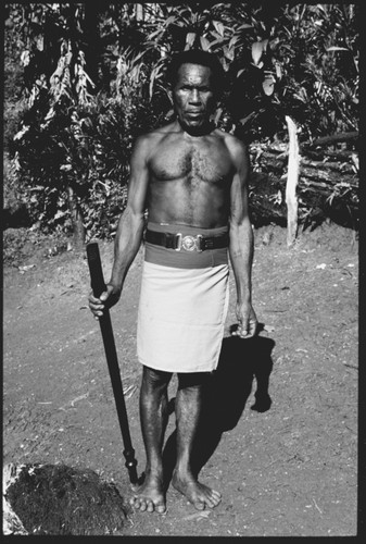 Man posing with old police belt and afui, also alafolo, club